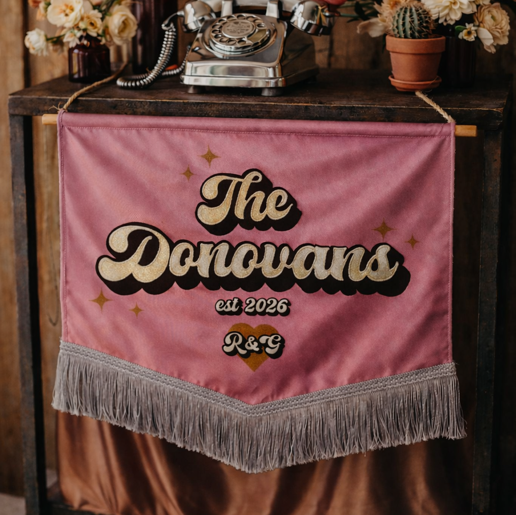 Decorative setup with flowers, vintage phone, and 'The Donovans' banner on a wooden table.